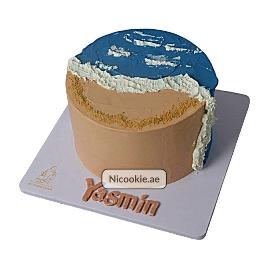 Beach wave buttercream cake with sand and ocean design.