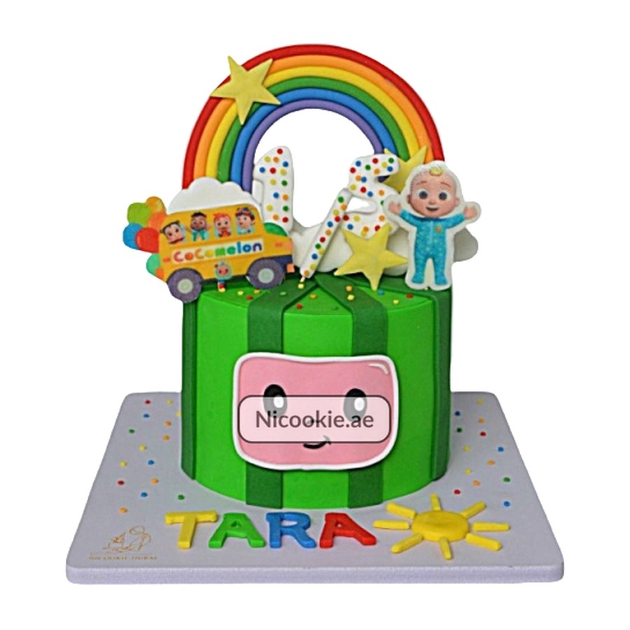 Cocomelon rainbow cake with a bus, characters, and numbers 1 and 2.