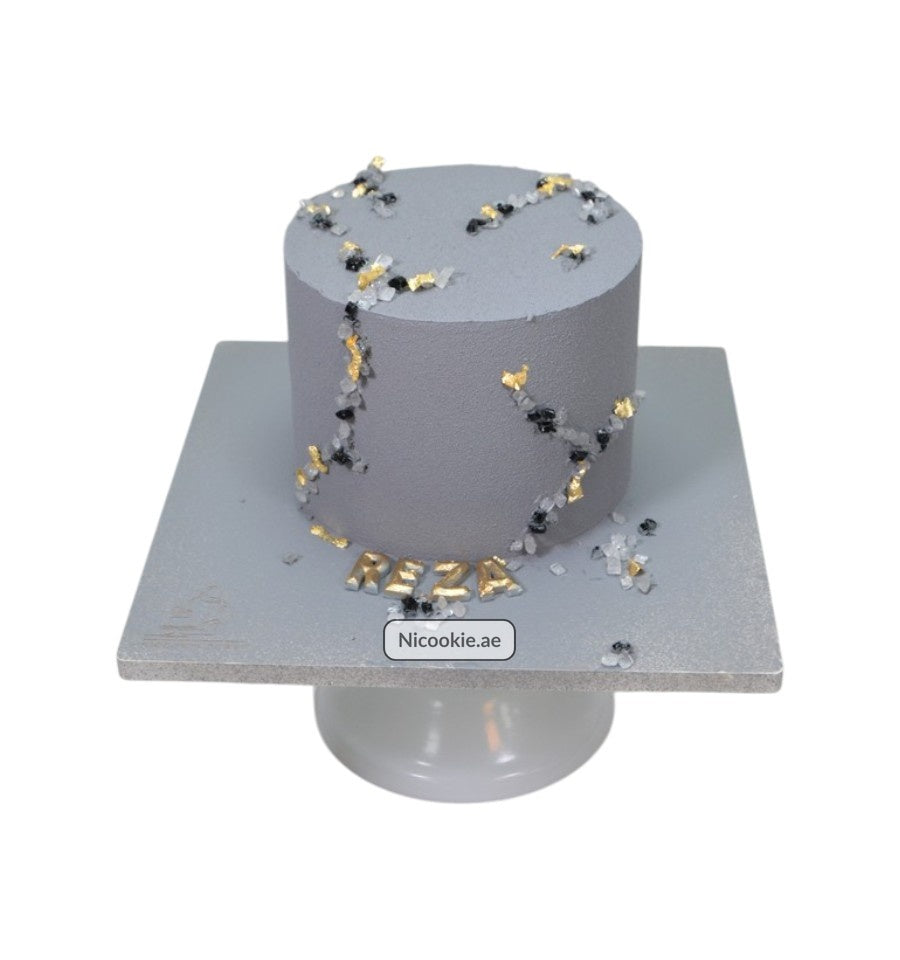 Cosmic Crystal Cake with gray frosting and crystal and gold accents.