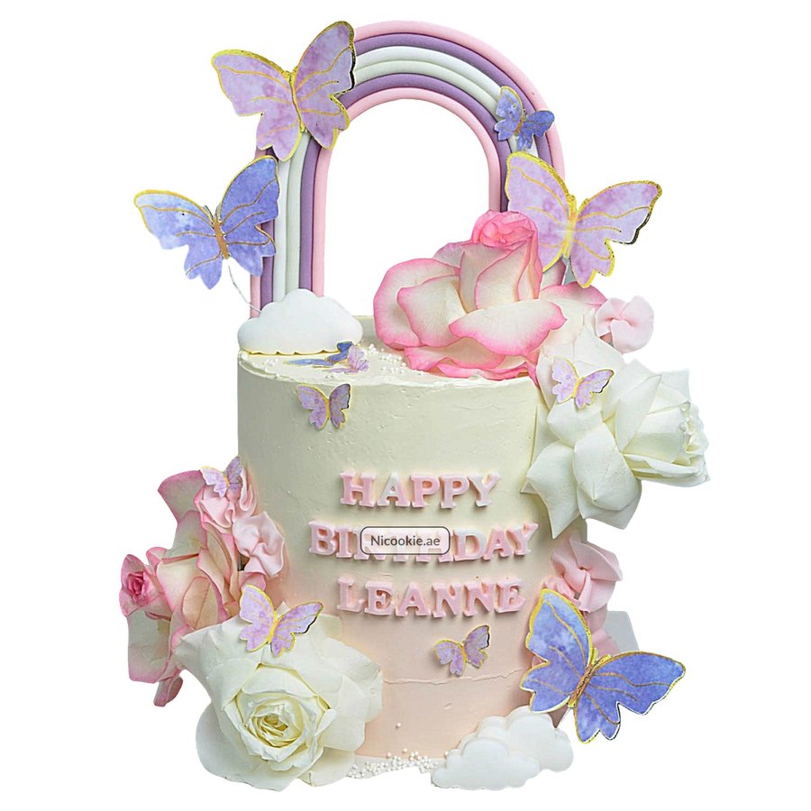 A pastel birthday cake with a rainbow, butterflies, and roses.
