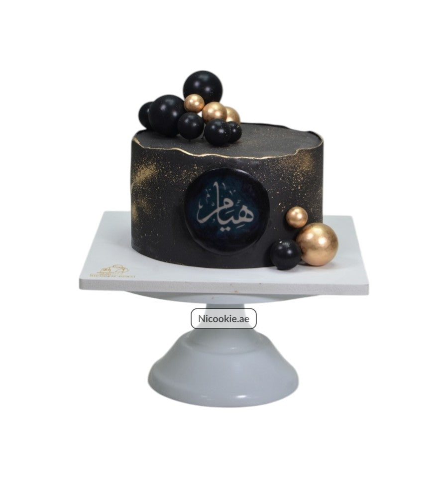 Galactic Elegance Cake with black and gold spheres and Arabic calligraphy.