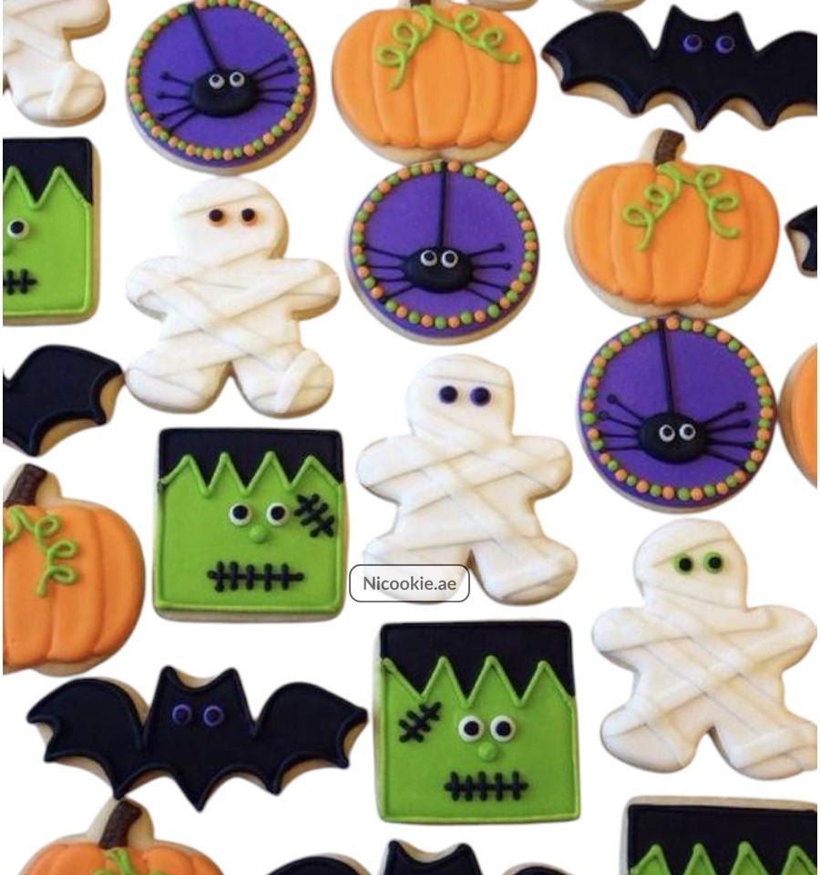 Halloween cookies featuring mummies, pumpkins, spiders, Frankenstein, and bats.