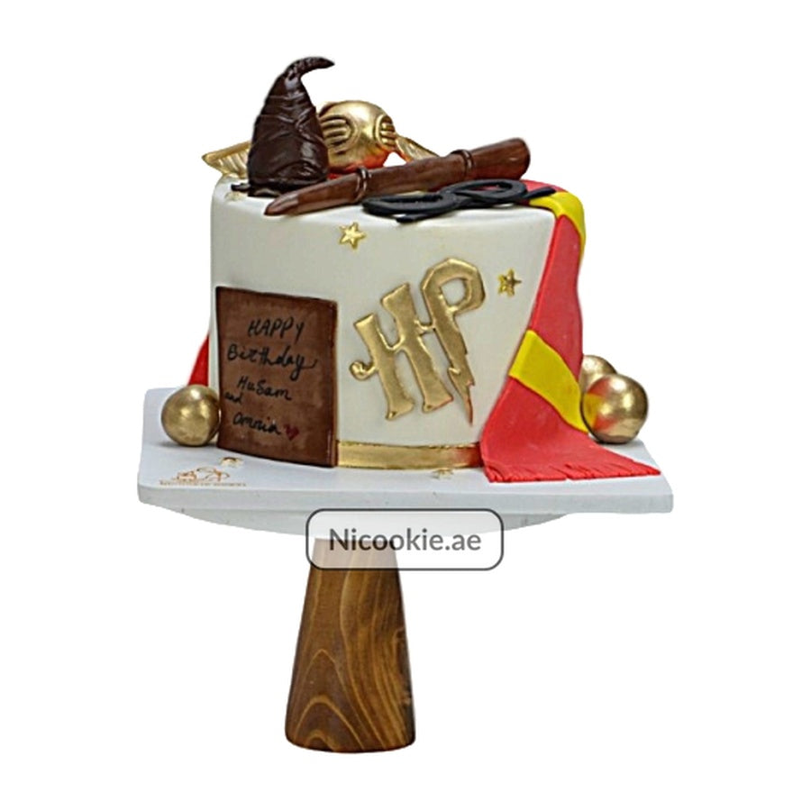 Hogwarts Magic cake with Sorting Hat, golden snitch, wand, and scarf.