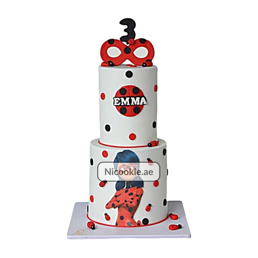 Ladybug Miraculous cake with polka dots, ladybugs, and a number 3 topper.