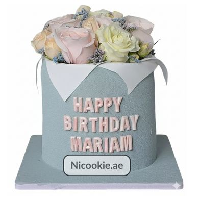 A blue cake with pastel roses and "Happy Birthday Mariam" text.