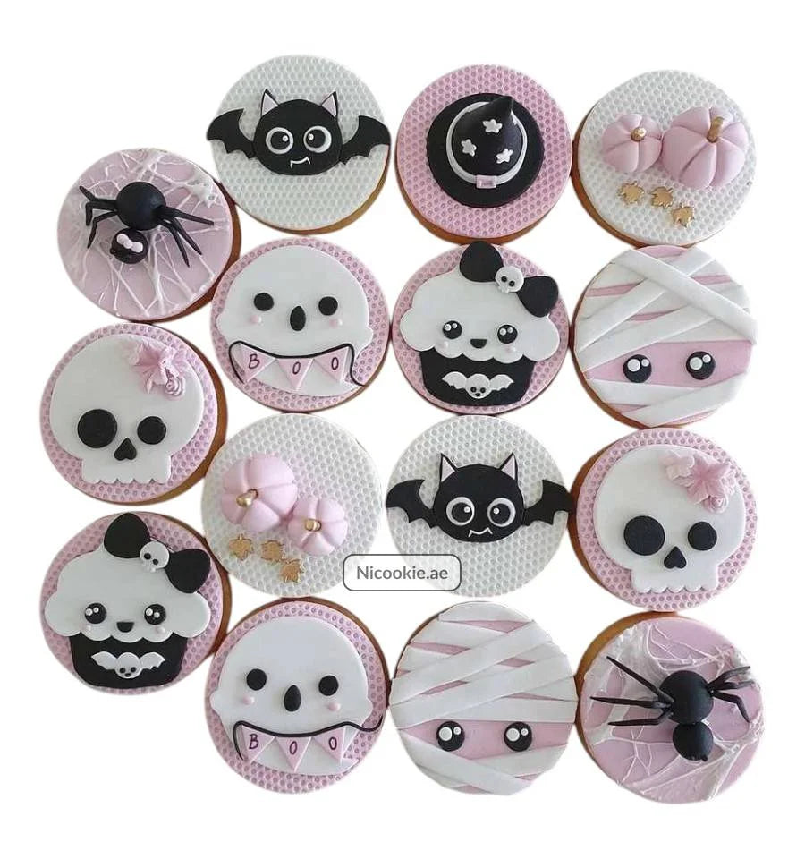 Pastel Halloween cookies with bats, mummies, skulls, pumpkins, and spiders.