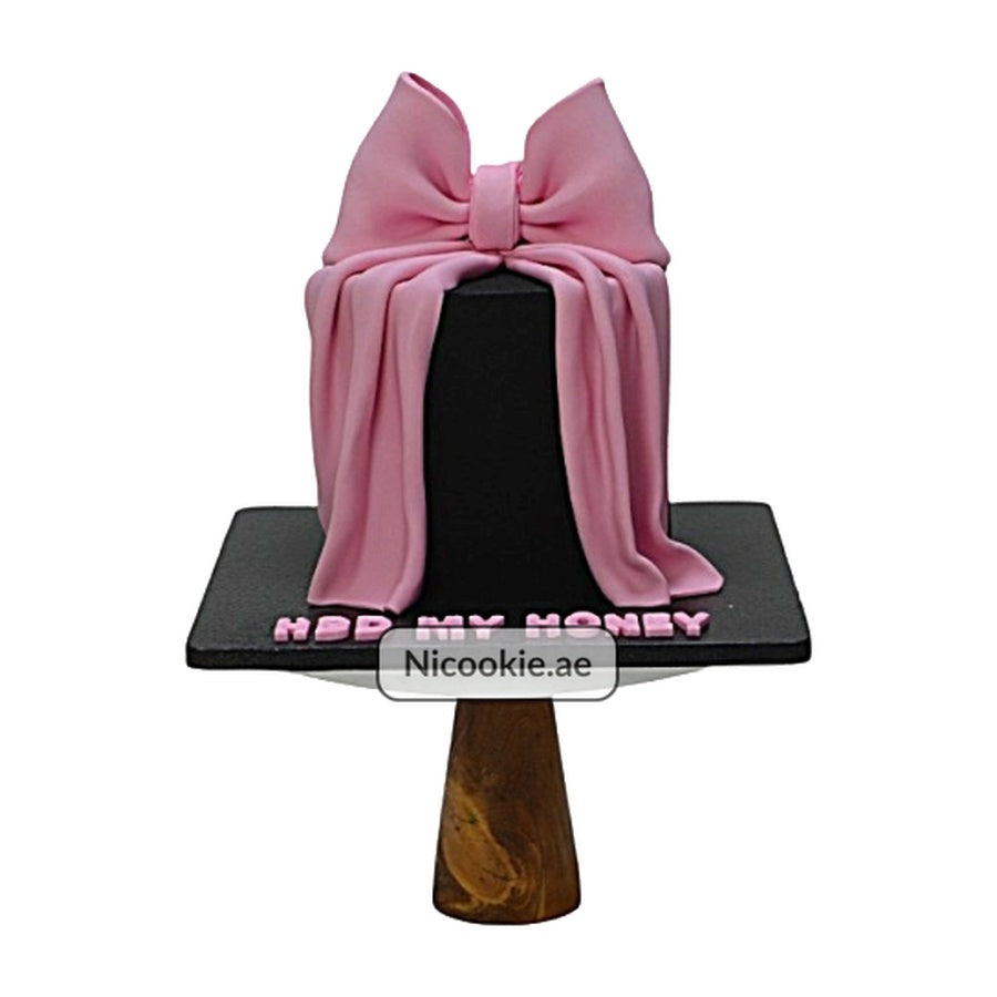 A black cake with a pink bow and "HBD MY HONEY" text.