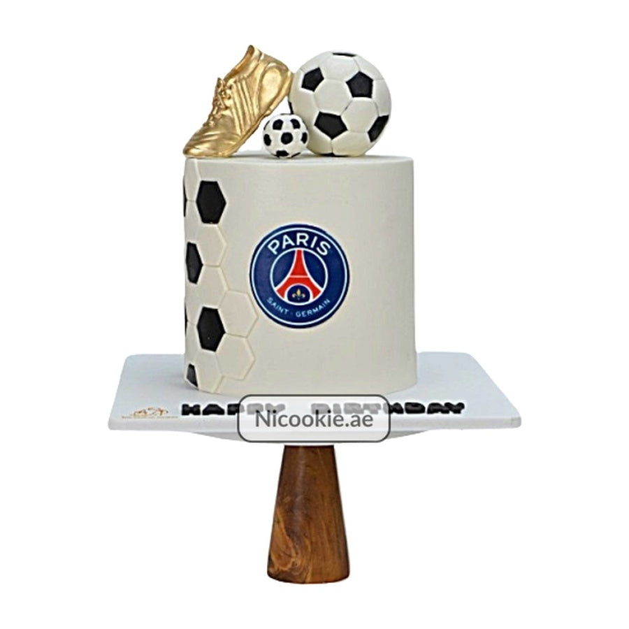 A Paris Saint-Germain football cake with a golden shoe and soccer balls.
