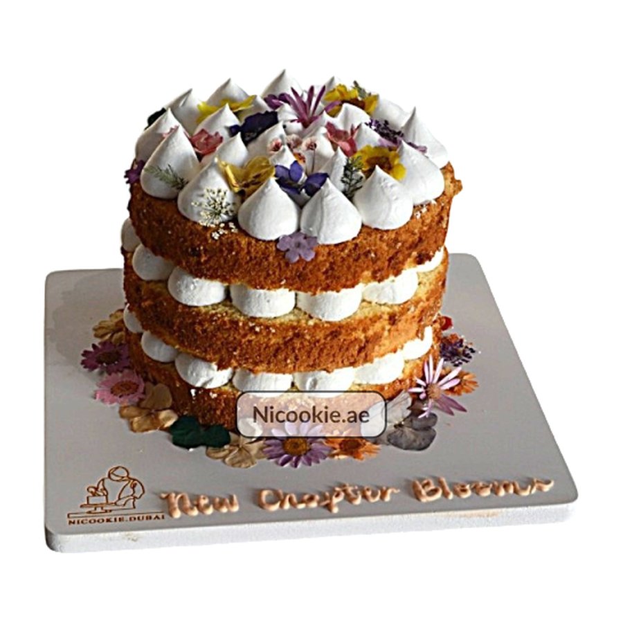 A three-layer rustic cake with whipped cream and edible flowers.