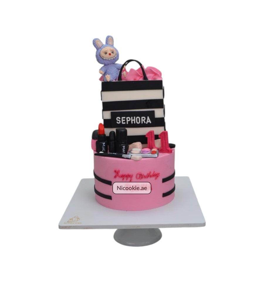 Sephora themed cake with makeup decorations and a bunny topper.