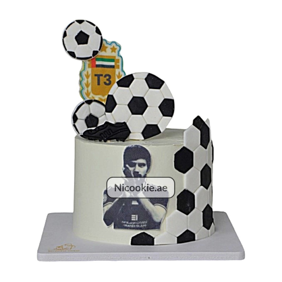 A soccer star cake decorated with fondant soccer balls and a player's photo.