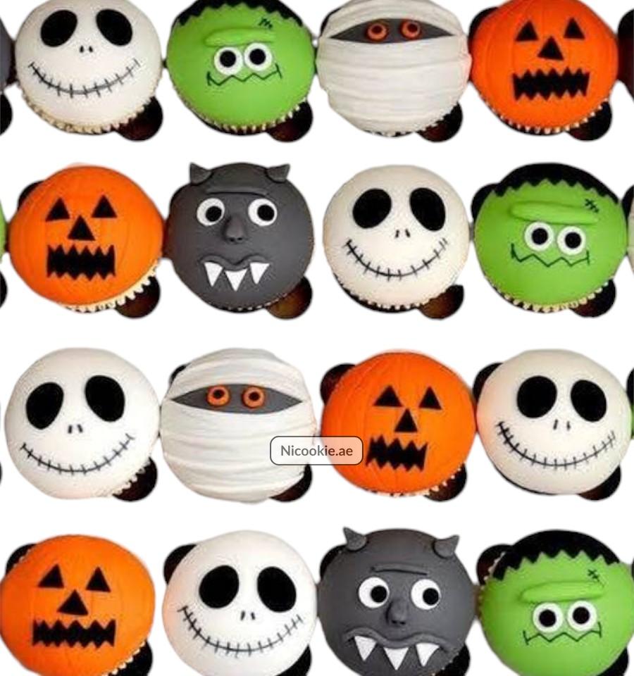 Spooky character cupcakes with Halloween designs like mummies and pumpkins.