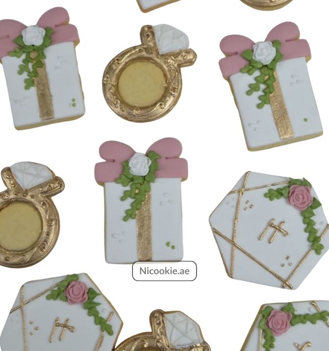 Golden Elegance cookies shaped like gifts, rings, and hexagons with floral and bow details.