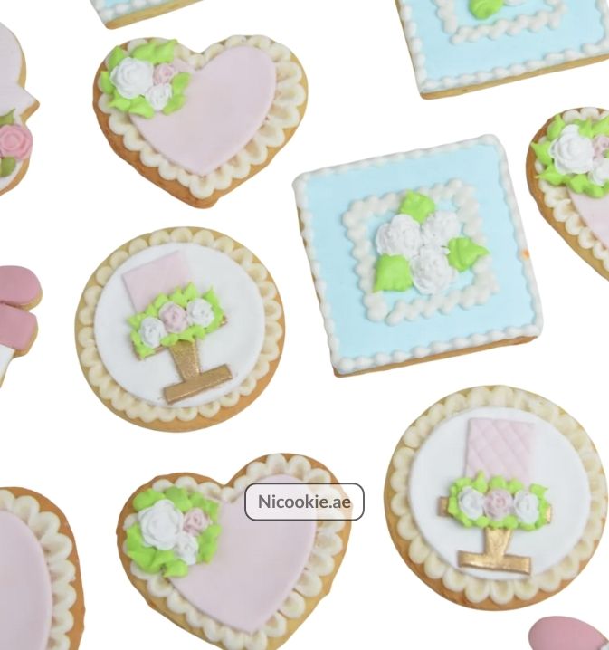 Pastel garden cookies with floral and heart designs.