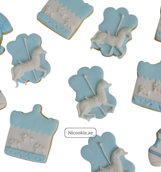 Carousel cookies with white horses on blue backgrounds.