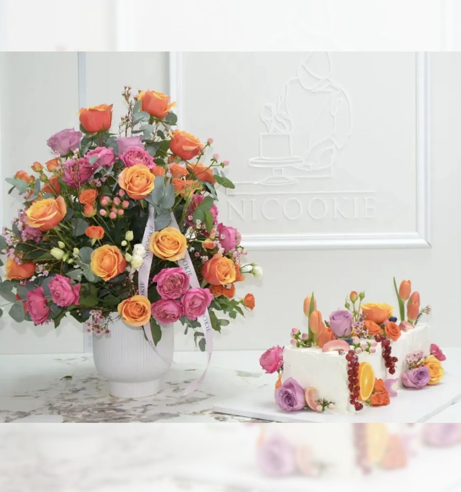 Sunset Garden Roses & Cake Set with orange, pink, and yellow blooms.