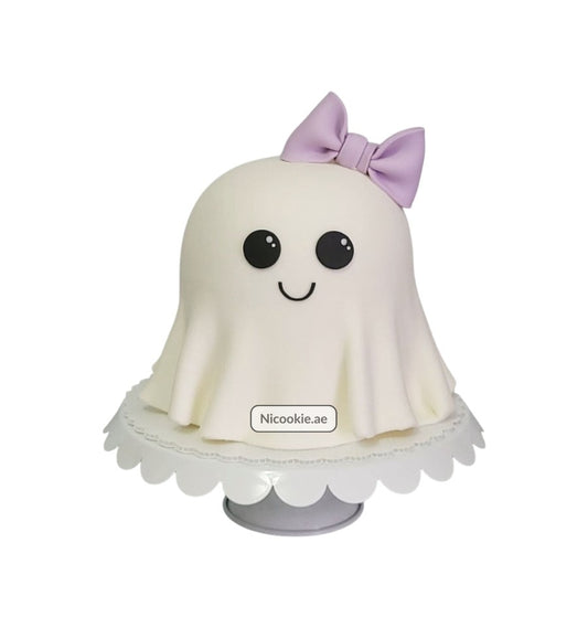Adorable ghost cake with a purple bow and a happy face.