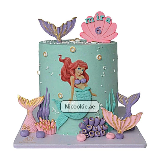 Ariel mermaid cake with fondant Ariel, fish tails, and underwater decorations.