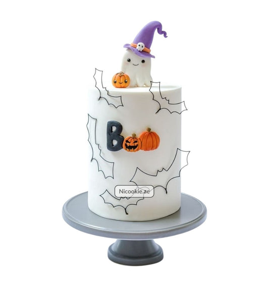 A Halloween cake with a ghost, pumpkins, and bats.