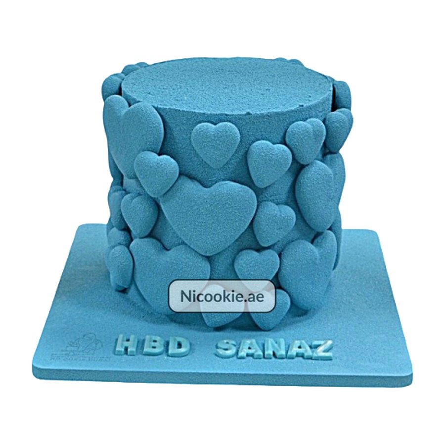 Blue cake decorated with blue velvet hearts and "HBD SANAZ" on the base.