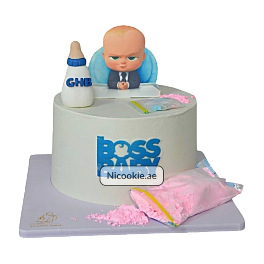 Boss Baby cake with a baby figure, bottle, and pink powder.