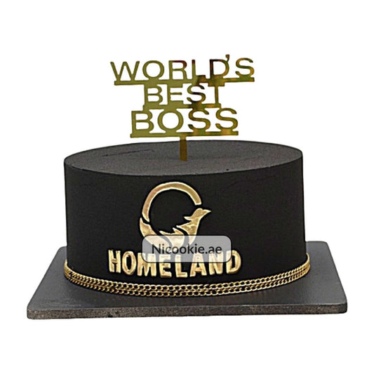 Black cake with gold "World's Best Boss" topper and "Homeland" logo.