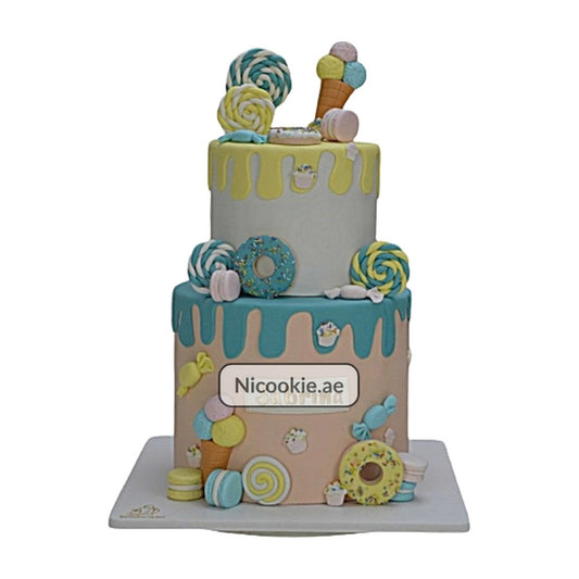 A two-tier cake decorated with colorful candies, donuts, and ice cream.