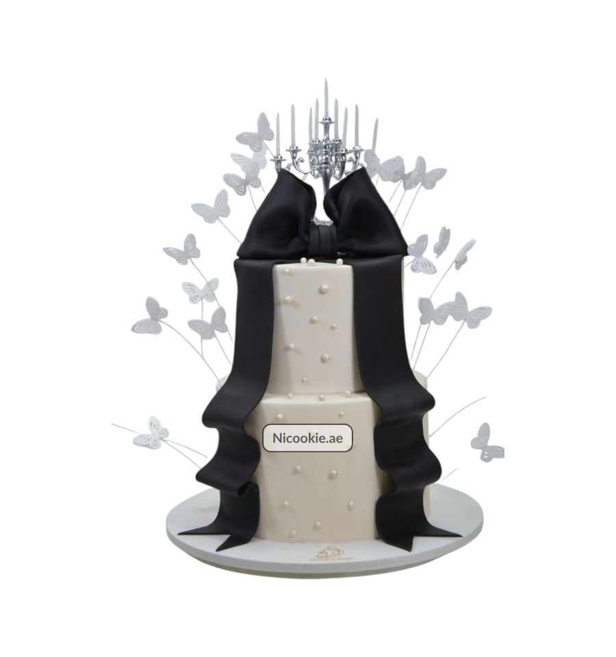 Chandelier Elegance Cake with black ribbon, pearls, and butterflies.