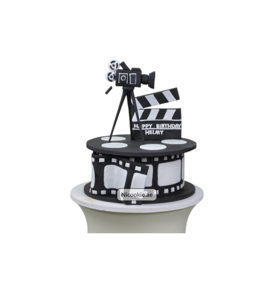 Cinematic Celebration Cake with movie camera and clapperboard decorations.