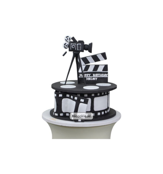 Cinematic Celebration Cake with movie camera and clapperboard decorations.