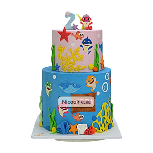 Two-tiered Baby Shark cake with underwater decorations.