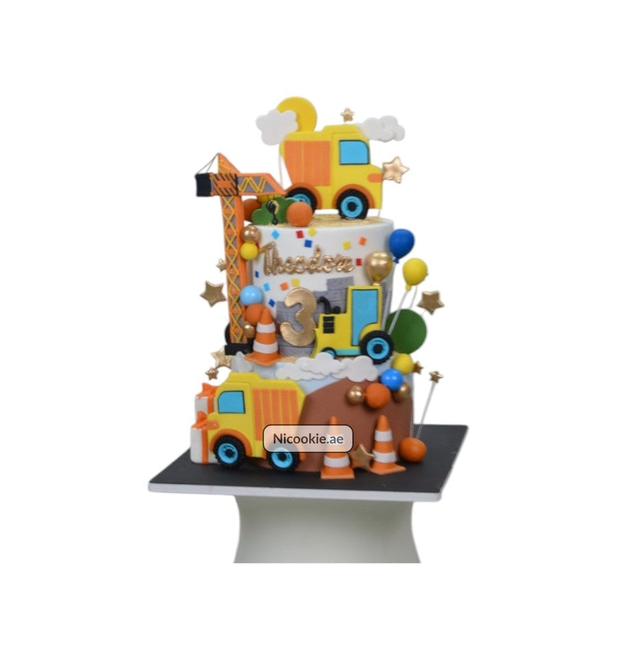 Construction themed cake with trucks, cranes, and the number 3.