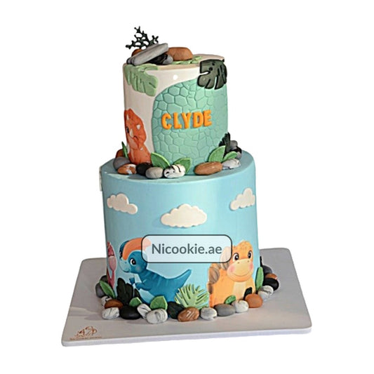 Cute two-tier dinosaur adventure cake with fondant decorations.