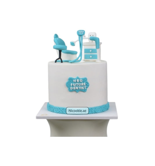 A white cake decorated with a dental chair, tools, and "HBD FUTURE DENTIST" text.