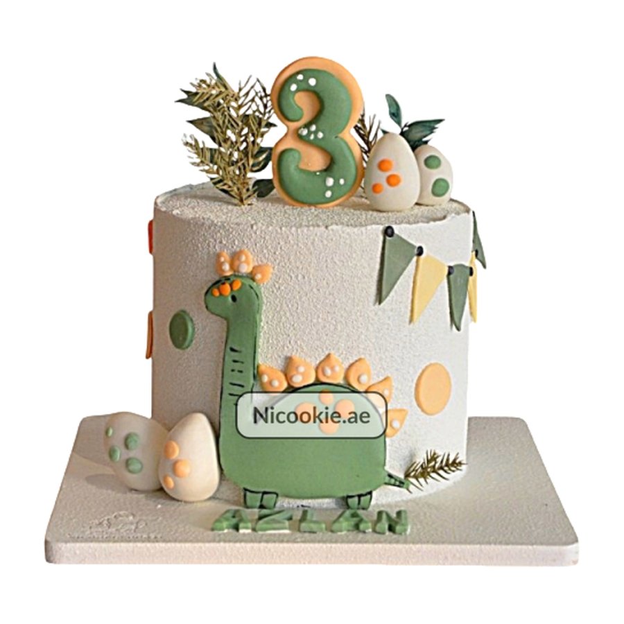 A dinosaur-themed birthday cake with a number 3 topper and fondant decorations.