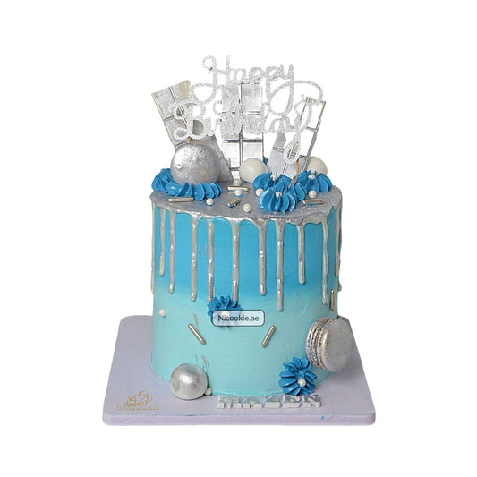 A blue and silver drip cake with "Happy Birthday" topper.