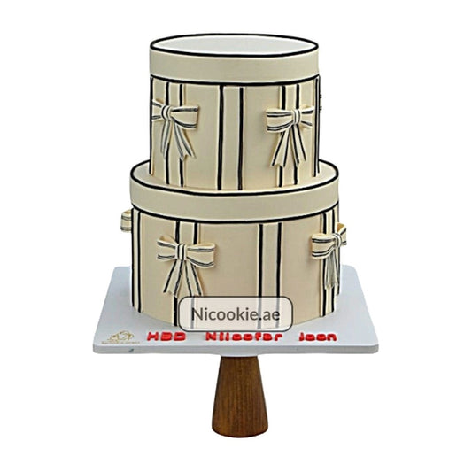 Elegant two-tier cake designed as a gift box with black stripes and bows.