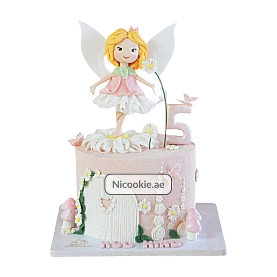 A fairy garden cake with a fairy topper, flowers, mushrooms, and a number 5.