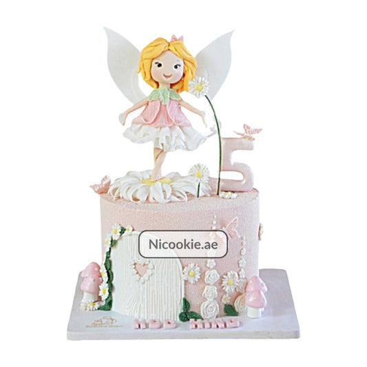 A fairy garden cake with a fairy topper, flowers, mushrooms, and a number 5.