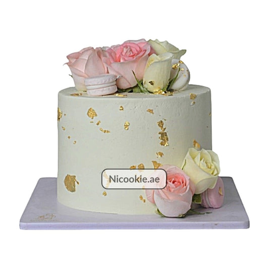 Floral Macaron Cake with roses and gold leaf.
