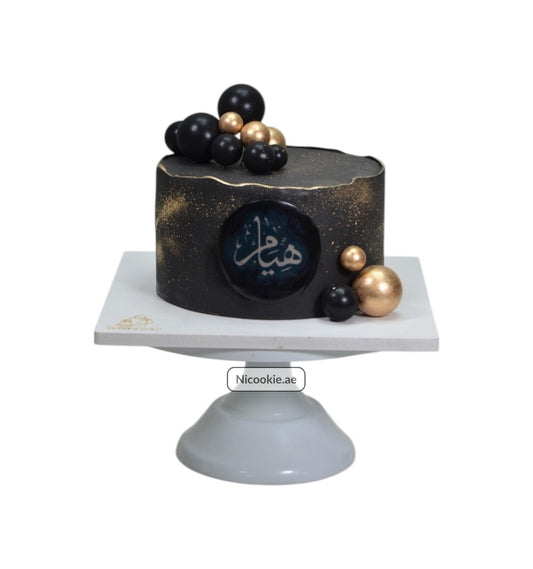 Galactic Elegance Cake with black and gold spheres and Arabic calligraphy.