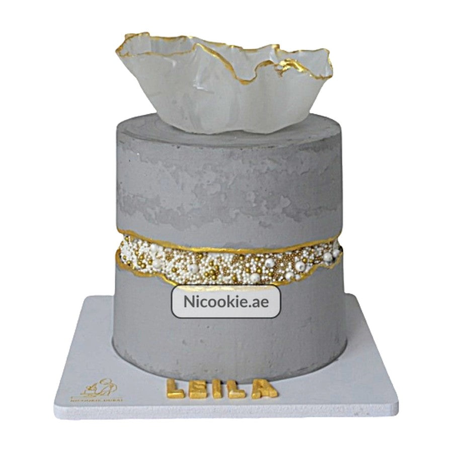 Gray and gold pearl modern birthday cake with a ruffled sugar sculpture.