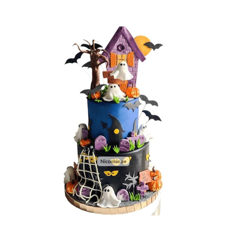 A three-tiered Halloween cake decorated with ghosts, bats, pumpkins, and a haunted house.