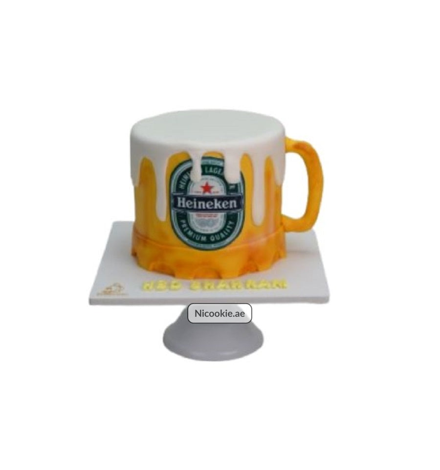 Heineken mug cake with frothy white icing and a Heineken label.