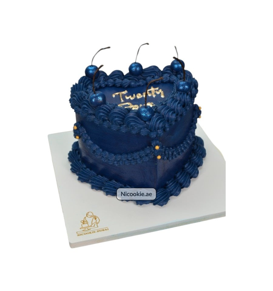 Midnight blue cake with shimmering cherries and gold accents.