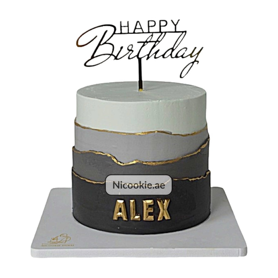 Monochrome layered cake with gold accents and "Happy Birthday Alex" topper.