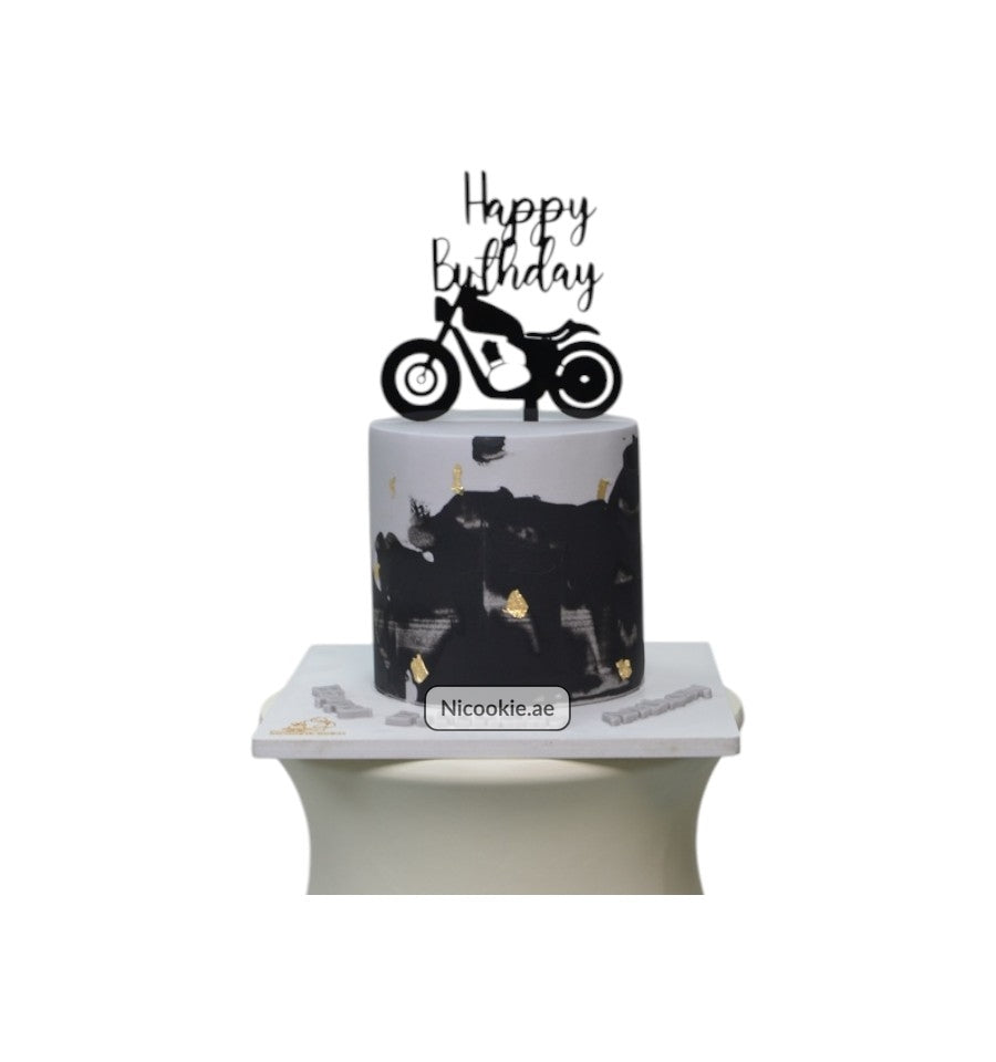 Motorcycle birthday cake with black and gold accents.
