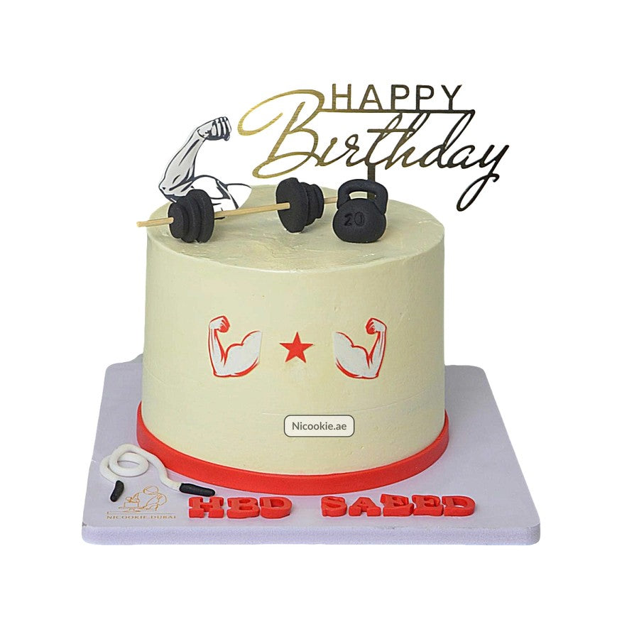 A fitness-themed birthday cake with weights, barbell, and "Happy Birthday" topper.