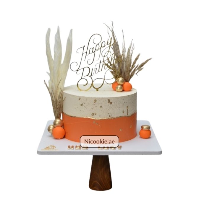 Terracotta Boho cake with dried florals and gold accents.