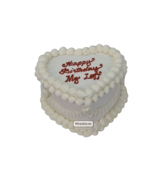 Heart-shaped cake with white frosting and "Happy Birthday My Leff" written in red.